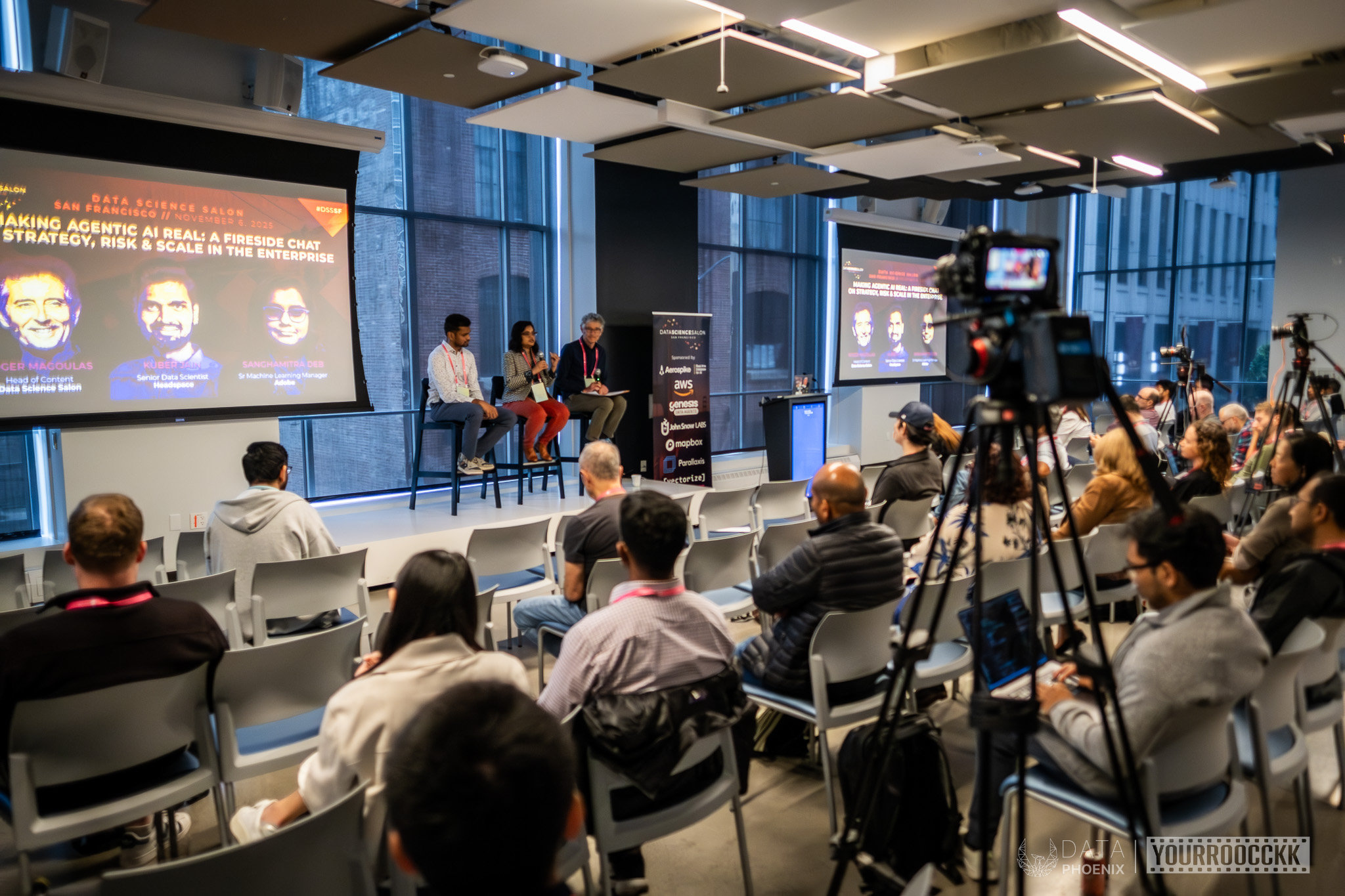 Fireside chat on agentic AI at Data Science Salon SF, with audience, screens and a banner listing AWS among sponsors