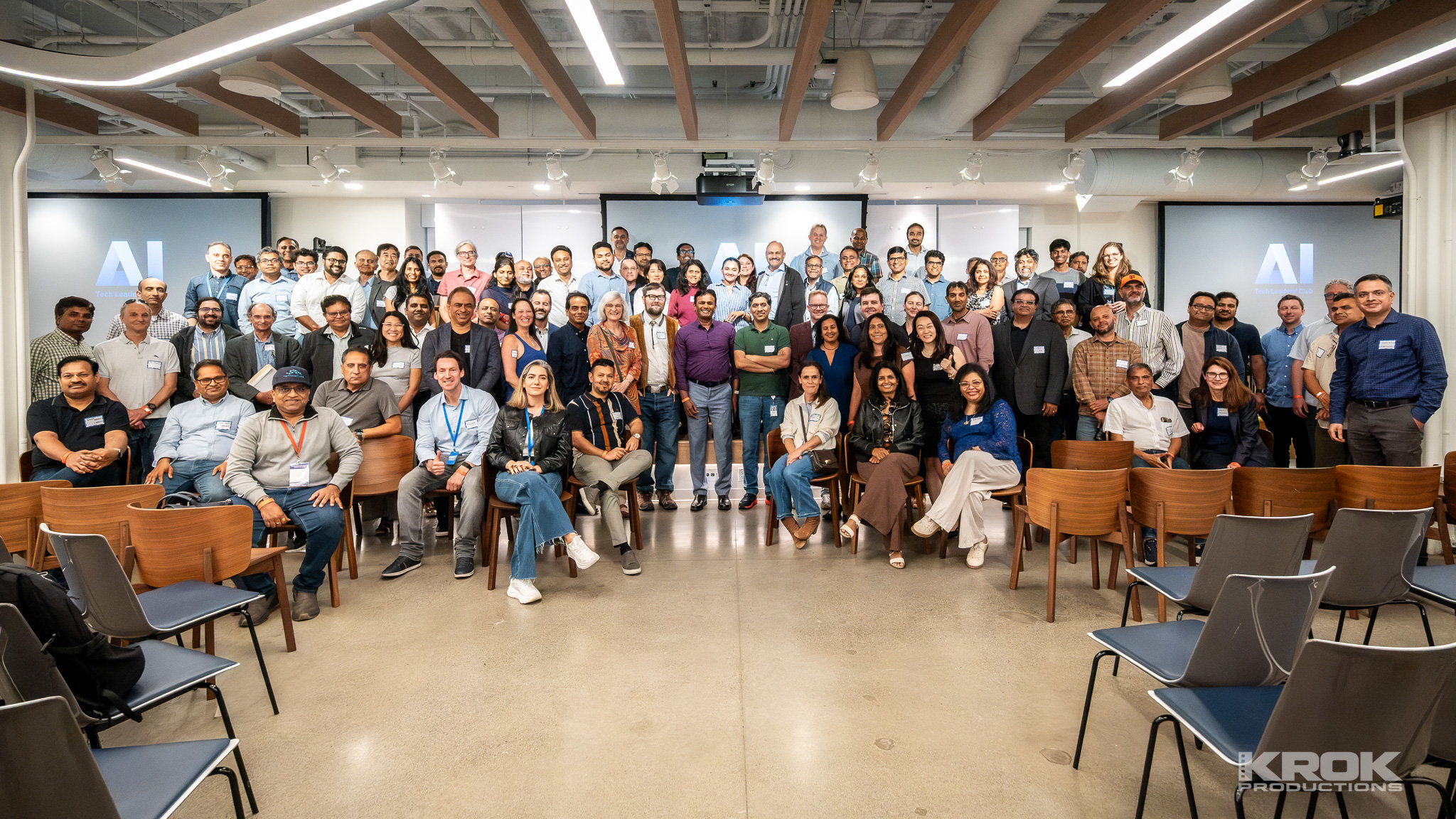 Group photo of AI Tech Leader's Club Q2 2026 attendees in a meeting room with AI-branded screens